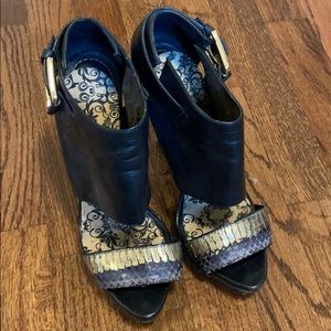 Black leather heels with gold croc detail